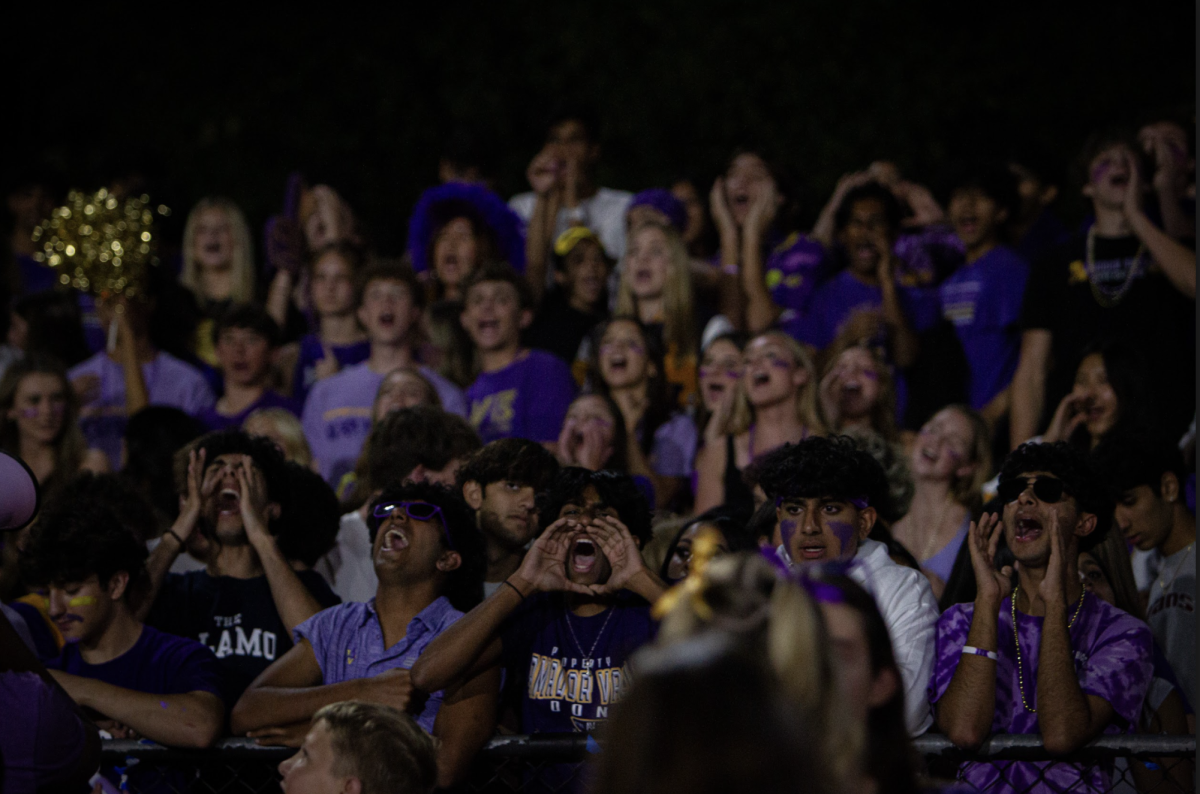 Amador's vibrant crowd of supporters, face painted and voices raised, erupt in cheers and excitement showing unwavering support for the varsity team in the electrifying atmosphere.